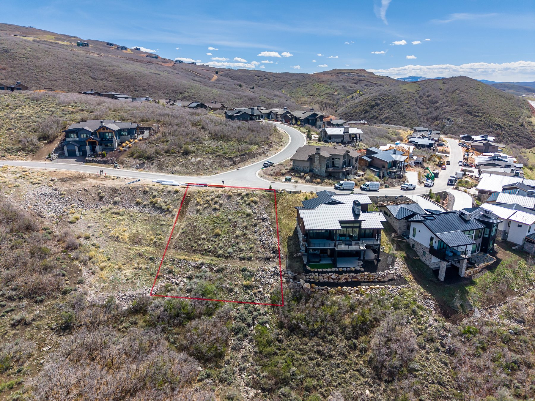 Soaring Hawk at Hideout neighborhood aerial view showing mountain modern homes and active construction surrounding 11461 N White Tail Court